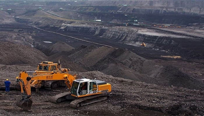 The image shows workers busy on a coal mining project. — APP/ File