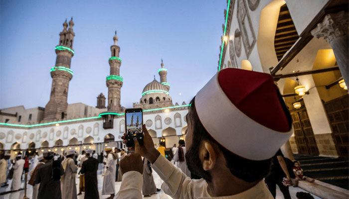 A representational image showing a person taking a picture inside a mosque. — AFP/File