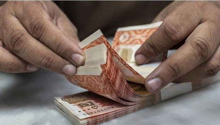 A person counting Pakistani currency note.—AFP/File