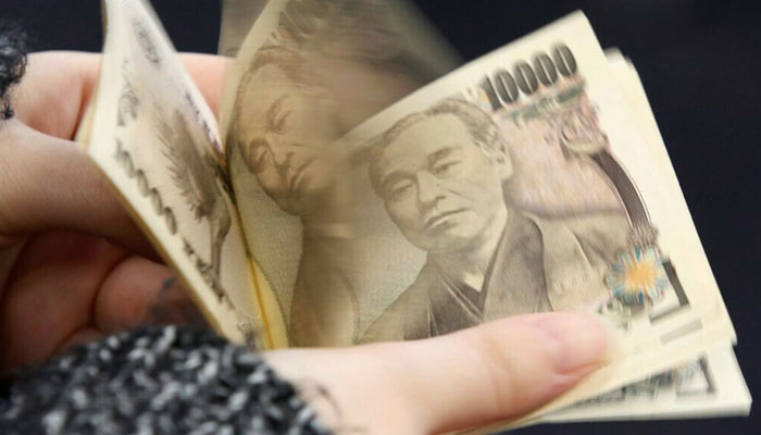 This photo illustration shows Japanese 10,000 yen banknotes in Tokyo on November 19, 2021. — AFP