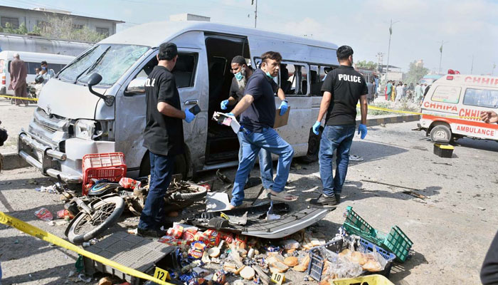 Security officials examine the site after suicide attack on a convoy of foreign nationals in Karachis Landhi area on April 19, 2024. — APP