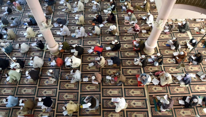 this representational image shows Islamic religious students taking mid-term exams at Jamia Binoria, a seminary in Karachi. — AFP/File