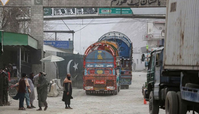 Goods carrier trucks cross into Pakistan at the zero point Torkham border crossing between Afghanistan and Pakistan, in Nangarhar province on February 25, 2023. —  AFP