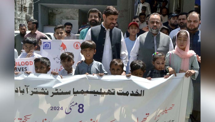 KP Health Minister Syed Qasim Ali Shah along with KP Al-Khidmat Foundation President Khalid Waqas hold an awareness walk on the occasion of World Thalassemia Day in Peshawar on May 8, 2024. — PPI