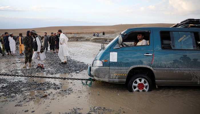 A minivan is being towed out of the flood water in the Khushi district of Logar, Afghanistan, August 21, 2022. — Reuters