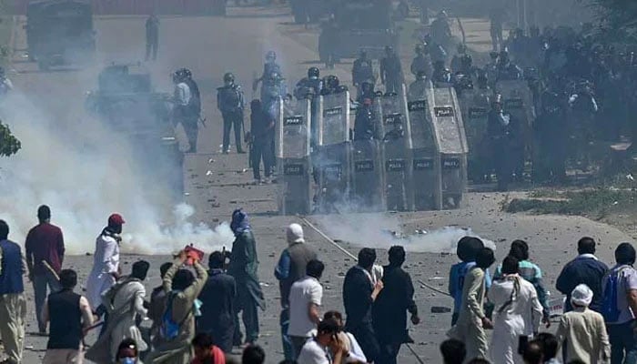 PTI activists and supporters of former prime minister Imran Khan clash with policemen during a protest against the arrest of their leader, in Islamabad on May 10, 2023. — AFP