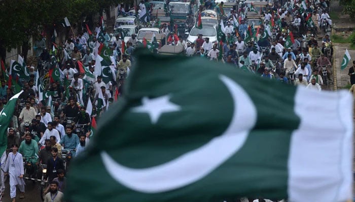 People take part in a march to celebrate Pakistans 75th Independence Day in Karachi on August 14, 2022.— AFP