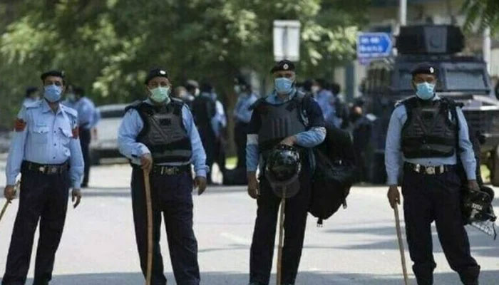 Islamabad Capital Police police personnel stand guard on the road of Islamabad. — APP/File