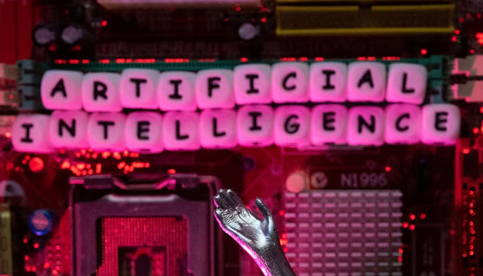 AI (Artificial Intelligence) letters and robot hand are placed on computer motherboard in this illustration taken, June 23, 2023. — Reuters