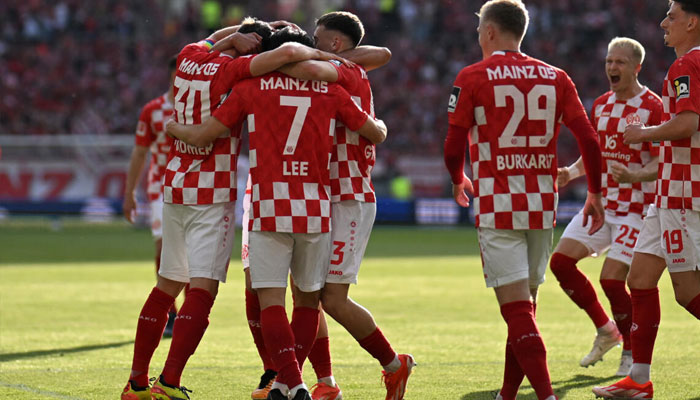 Mainzs South Korean midfielder Lee Jae-sung (3rdL) scored two goals as his side upset Borussia Dortmund and escaped the relegation playoff spot. — AFP/File