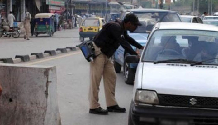 Rawalpindi Excise officer stops a vehicle at a checkpoint. — Islamabad Post/File