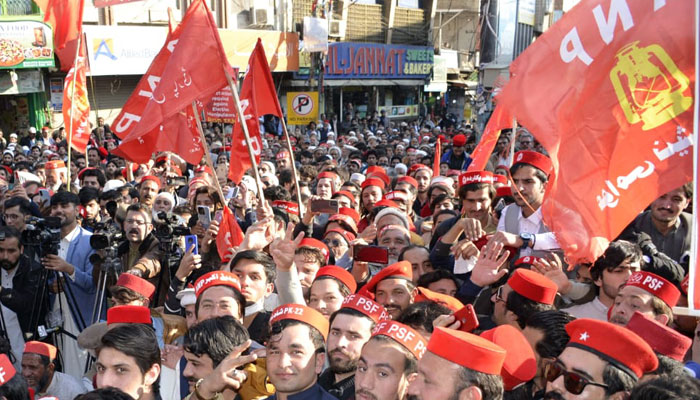 Workers and supporters of the Awami National Party hold flags in a rally on March 8, 2024. — Facebook/Awami National Party