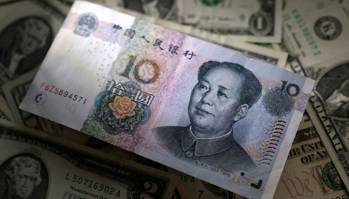 Chinese Yuan and U.S. dollar banknotes are seen in this illustration taken March 10, 2023. — Reuters