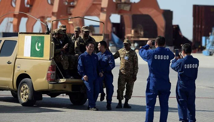 Chinese workers pose for a picture with Pakistani soldiers in Gwadar port, Pakistan. — AFP/File