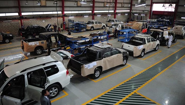 A representational image of vehicles being assembled in a factory. — AFP/File