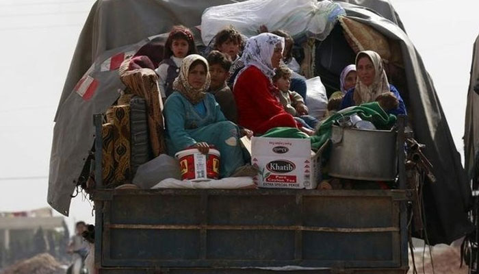 A representational image of internally displaced persons (IDPs) travelling on the back of a truck. — Reuters/File