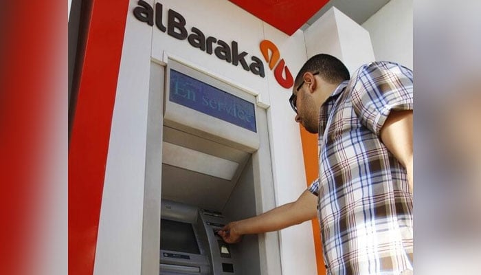 A man uses an automated teller machine (ATM) at the Islamic Bank of Al-Baraka. — Reuters/File