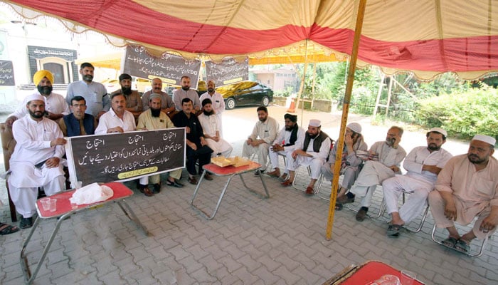 Members of Muttahida Ittehad Chairman and Members City Metro Peshawar hold protest outside City District office in Peshawar on May 16, 2024. — PPI