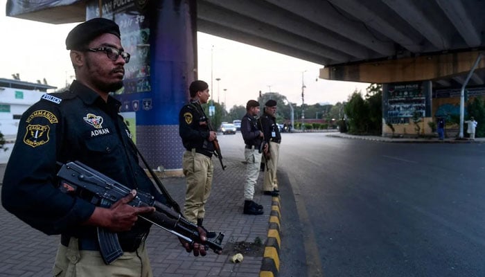 Police personnel can be seen standing guard in Karachi. — AFP/File