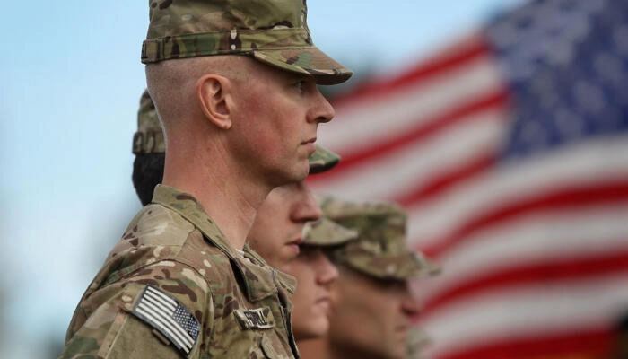 Soldiers bound for Afghanistan stand at parade rest during a departure ceremony on November 4, 2011 in Fort Carson, Colorado. — AFP/File