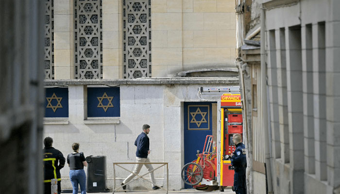 Police and fire brigade stand by a synagogue in the Normandy city of Rouen where French police have killed earlier an armed man who was trying to set fire to the building on May 17, 2024. — AFP