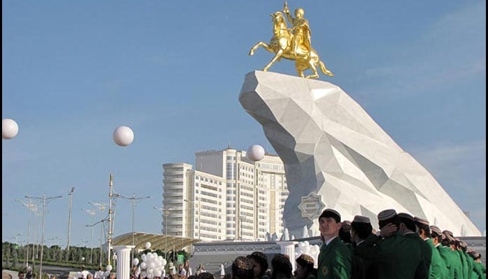 People take part in an opening ceremony of the first monument to Turkmenistans President Berdymukhamedov in Ashgabat on May 25, 2015. — AFP/file