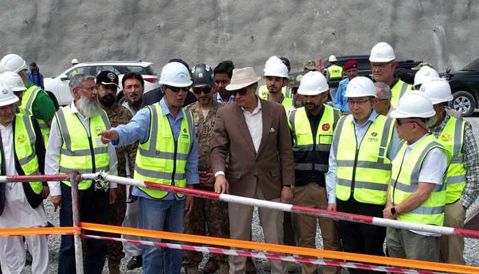 WAPDA Chairman Lt Gen Sajjad Ghani (retd) is briefed by officials on his visit to Diamer Basha Dam on May 17, 2024. — Reporter