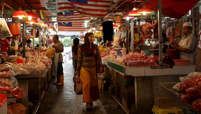 A woman shops in a wet market in Kuala Lumpur, Malaysia. — Reuters/File