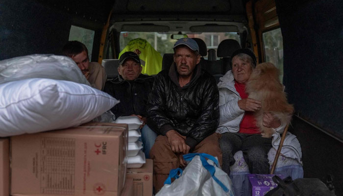 Ukrainian evacuees from the village of Lyptsi wait in a minivan at an evacuation point in Kharkiv on May 11, 2024. — AFP