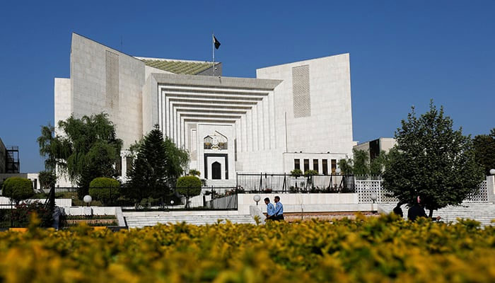 Police officers walk past the Supreme Court of Pakistan building, in Islamabad on April 6, 2022. — Reuters