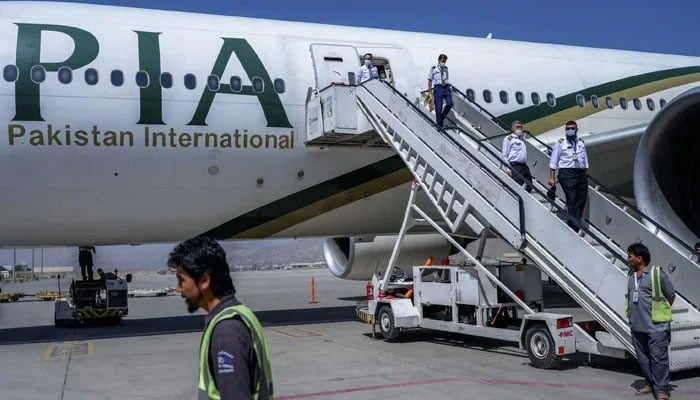 Crew members disembark from a Pakistan International Airways (PIA) flight at Kabul Airport. — AFP/File