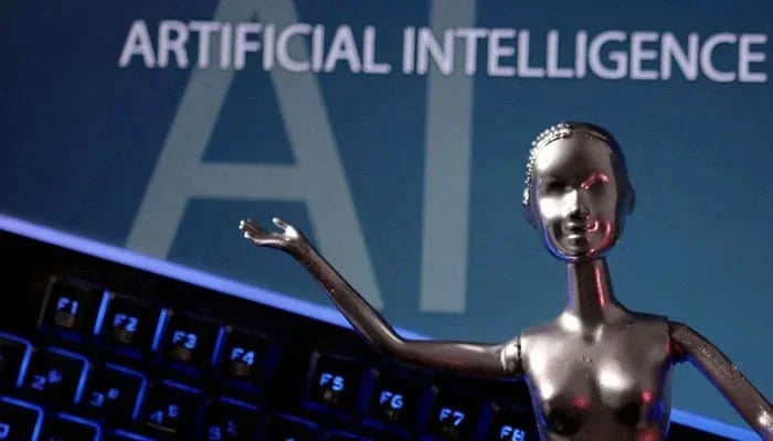 This representational picture shows a metallic figure against a computer. — AFP/File