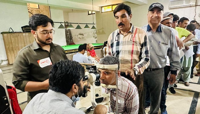 In this image, a doctor examines the patient at a free eye camp organised by the Lahore Press Club and Al-Ehsan Welfare Eye Hospital on May 19, 2024. — Facebook/Al Ehsan Welfare Eye Hospital