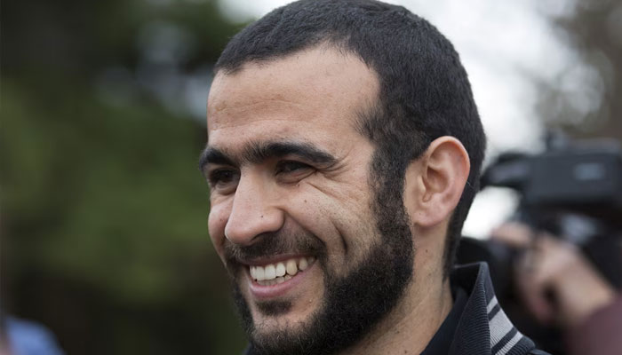 Omar Khadr smiles as he answers questions during a news conference after being released on bail in Edmonton, Alberta. — Reuters/File
