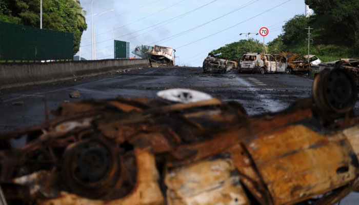 Burned cars seen on a road in this image.—AFP/file