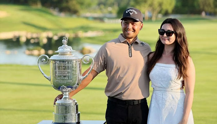 Xander Schauffele and his wife, Maya Schauffele, with the Wanamaker Trophy at Valhalla Golf Club in Louisville, Kentucky, on May 19. — AFP