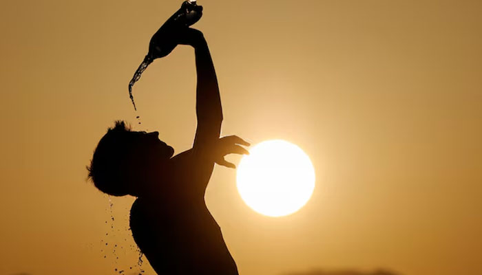 Man  cools down with water in this image. — Reuters/File