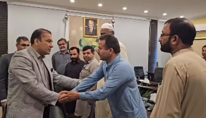 Chairman of the Capital Development Authority (CDA) Chaudhry Muhammad Ali Randhawa shaks hand with members of the fire-fighting squad in this still on May 21, 2024. — Facebook/Capital Development Authority - CDA, Islamabad