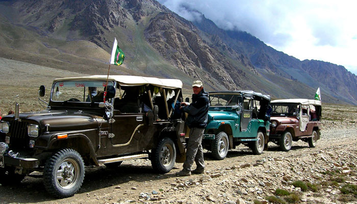 A tourist pictured with jeeps for transporting to mountainous resorts. —  hunzaguidespakistan website/file