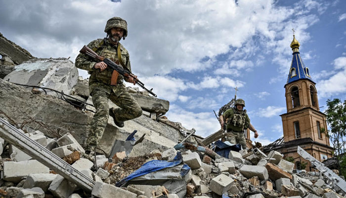 Ukrainian servicemen patrol an area heavily damaged by Russian military strikes in the town of Orikhiv in Zaporizhzhia region on May 20, 2024. — Reuters