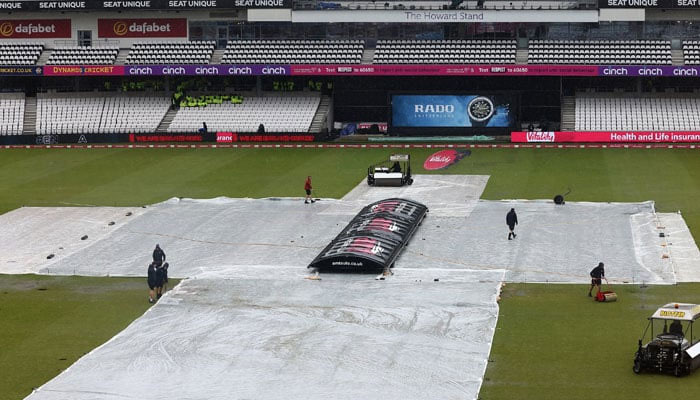 Ground staff convers the Headingley Cricket Ground during rain. — ECB/File