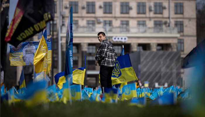 A man walks past Ukrainian flags at a memorial commemorating fallen servicemen who fought against Russia’s invasion of Ukraine, in Khreshchatyk Street in Kyiv, Ukraine, April 2, 2024. — Reuters
