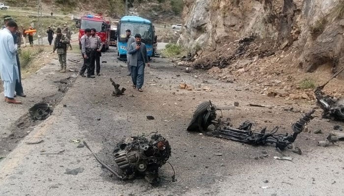 Vehicle parts can be seen on the road in the aftermath of the deadly suicide attack on bus carrying Chinese engineers on March 26, 2024. — X/@WaliKhan_TK