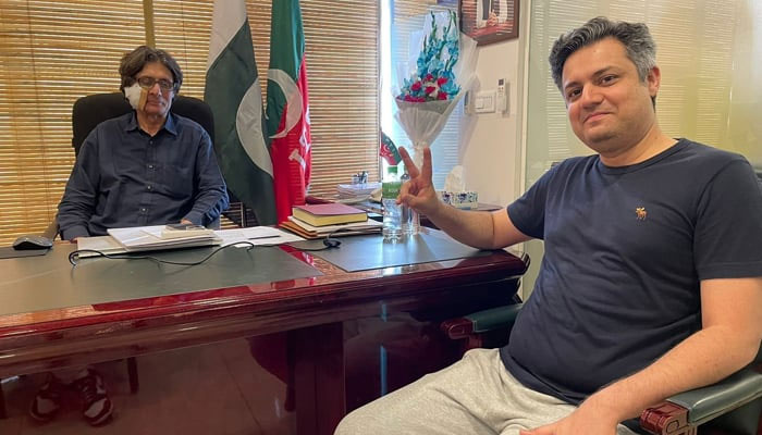 Former minister Hammad Azhar (right) poses for a picture with partys Information Secretary Raoof Hasan at PTI Central Secretariat in Islamabad on May 22, 2024. — X/@Hammad_Azhar
