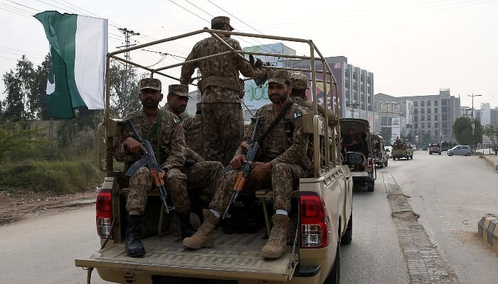 Pakistan Army and security forces personnel travel in military vehicles at an undisclosed location. —INP/File