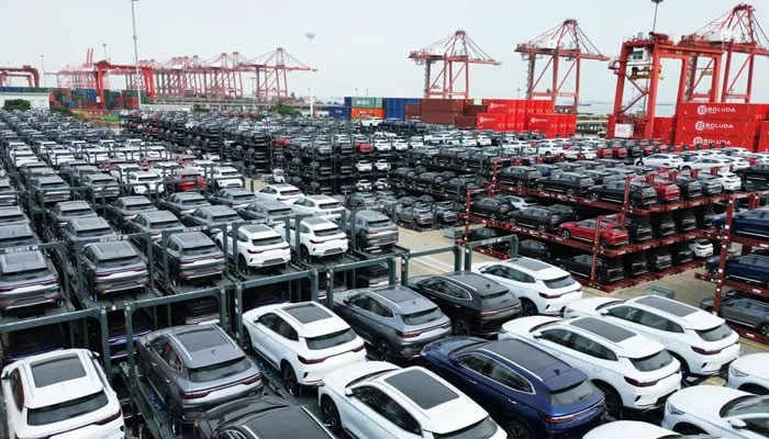 A representational image showing a large number of electric vehicles parked at a port. — AFP/File