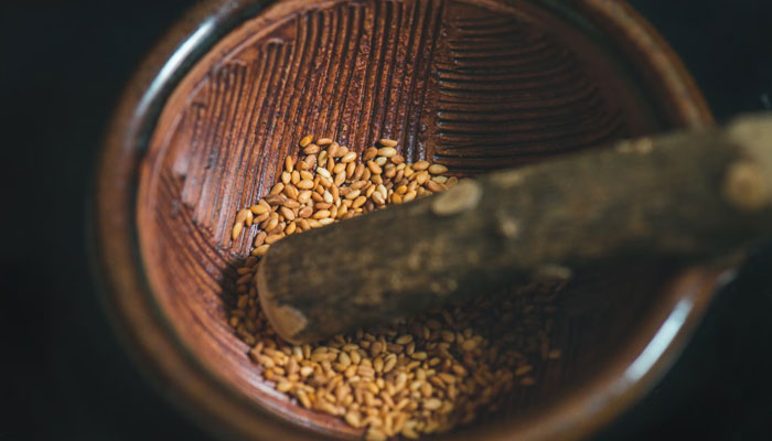 Sesame seeds are being crushed in a bowl. — Unsplash