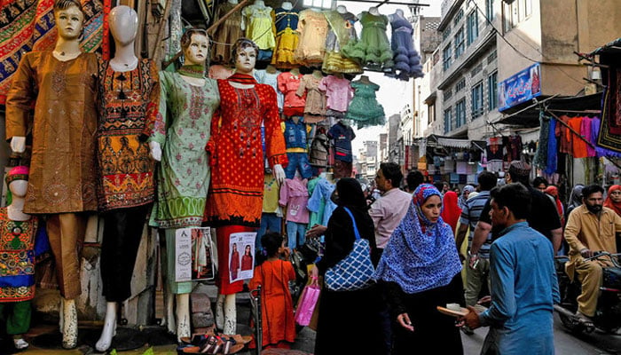 Shoppers crowd at a market area in Lahore. — AFP/File