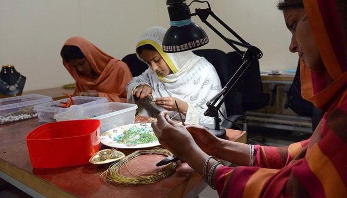 Employees prepare gemstones at a workshop in Peshawar. —  AFP/File