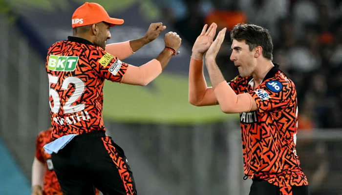 Sunrisers Hyderabads captain Pat Cummins (R) celebrates with teammate after taking a wicket during the IPL T20 first qualifier match between Sunrisers Hyderabad and Kolkata Knight Riders at the Narendra Modi Stadium in Ahmedabad on May 21, 2024. — AFP
